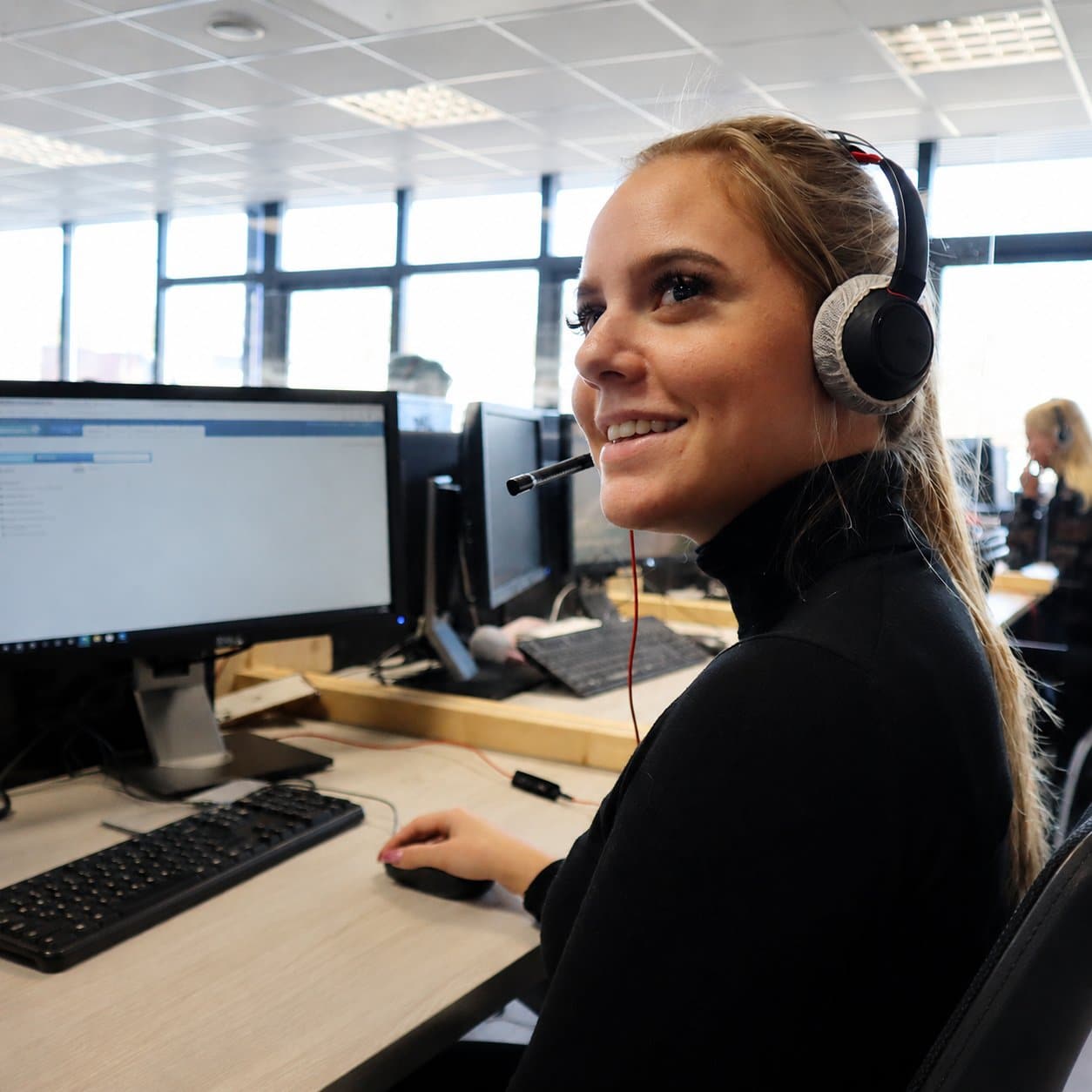 Contactcenter medewerker met headset helpt een NextEnergy klant